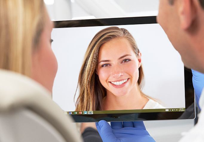 woman smiling on computer screen