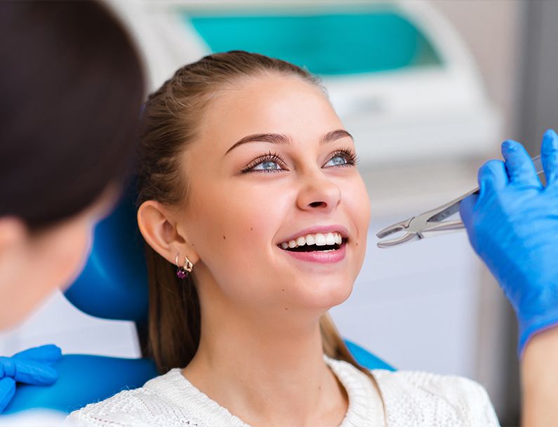 Plainview dentist perfoming tooth extraction