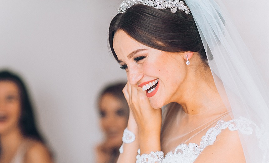 Woman in wedding dress laughing