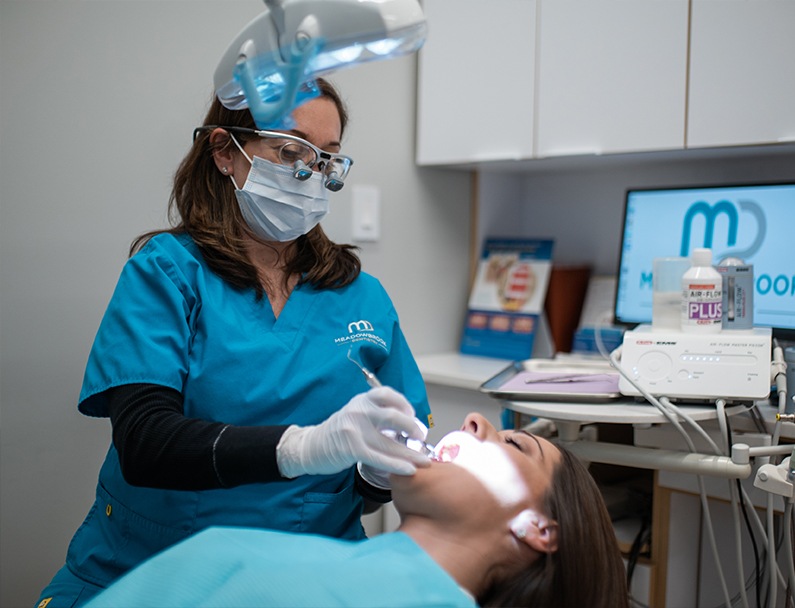 Plainview dental team member giving a patient a dental cleaning