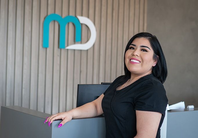 Meadowbrook Dentistry team member standing at reception desk