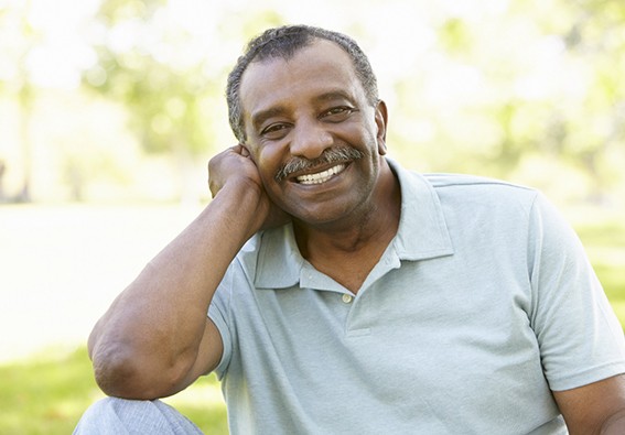 Man outside smiling with All On 4 in Plainview