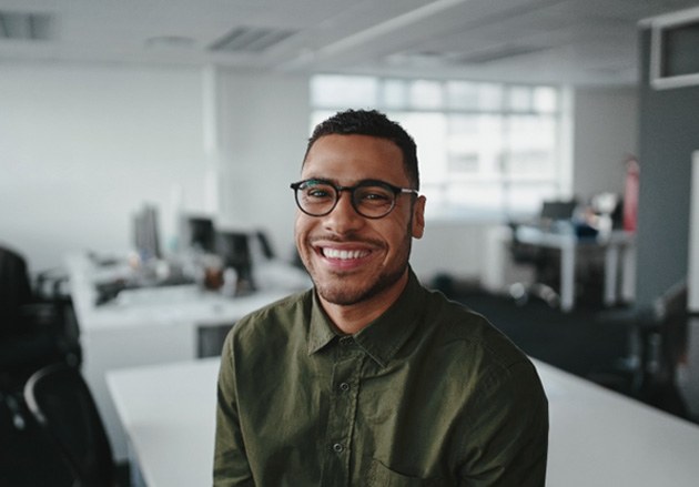 a smiling man with glasses