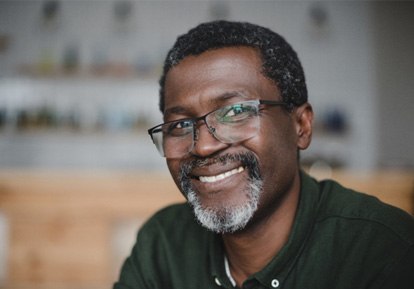 a smiling man with glasses