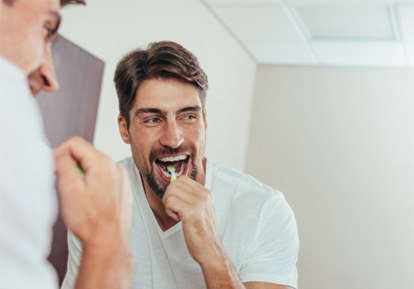 a man brushing his teeth