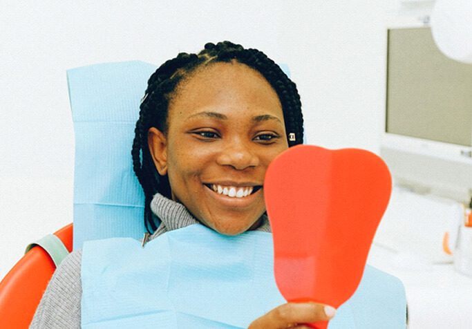 woman at dentist looking in a mirror