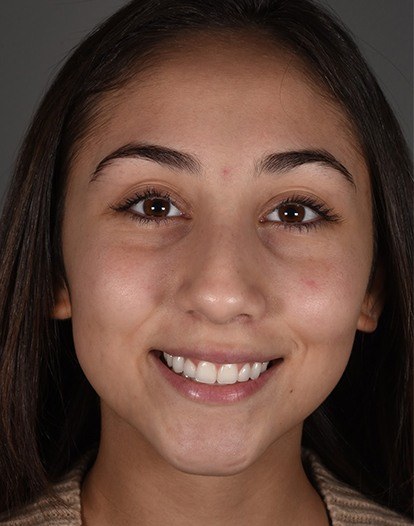 Young woman with dark hair smiling