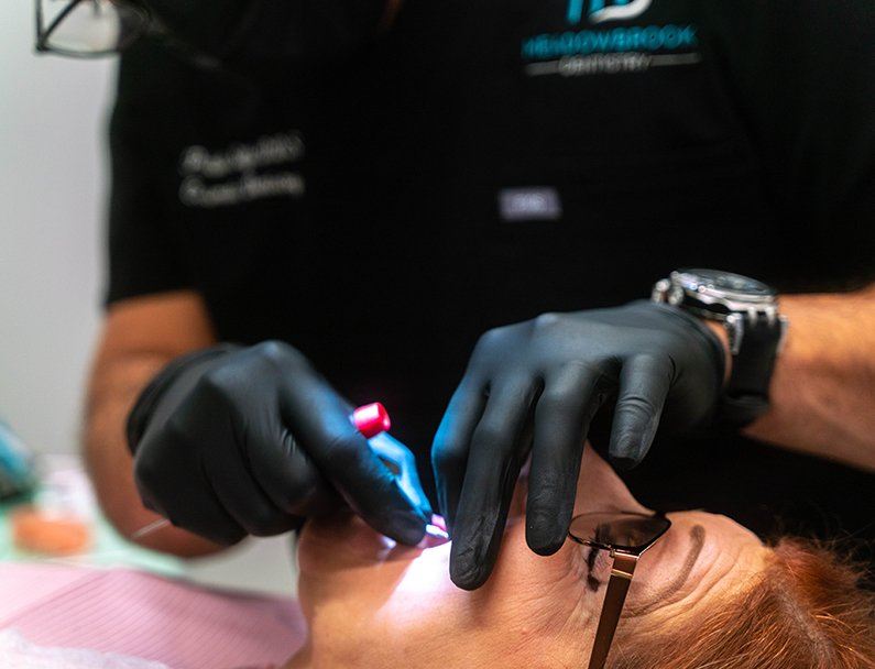 Dentist working on womans smile in chair