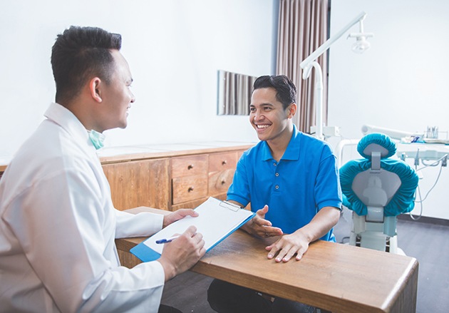 dentist talking to patient about cost of dental crowns