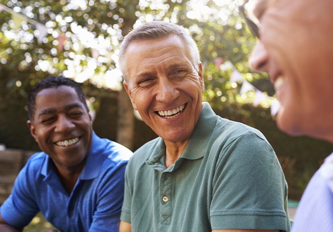 Men laughing with dentures in Plainview