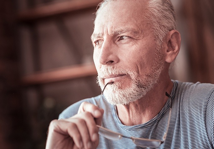 Man contemplating dentures in Plainview