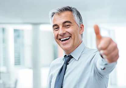 Man with dentures in Plainview smiling with thumbs up