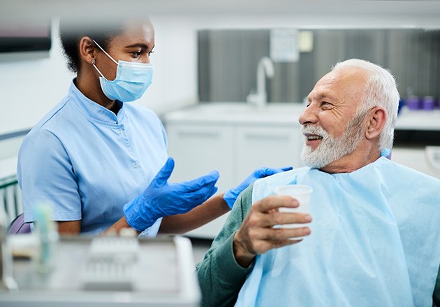 man asking questions about dentures in Plainview