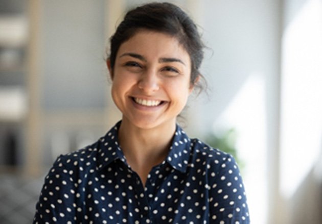 Woman in polka dot shirt smiling