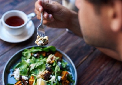 Closeup of patient eating healthy meal and drinking tea