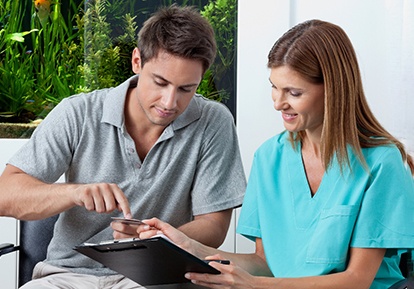 A patient paying for a tooth extraction