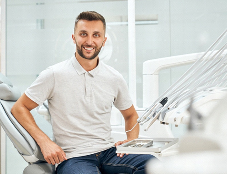 Man smiling after dental implant salvage in Plainview