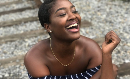 Laughing woman wearing black and white strapless top