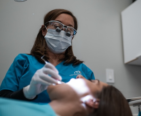 Smiling dental team member standing at front desk of Meadowbrook Dentistry