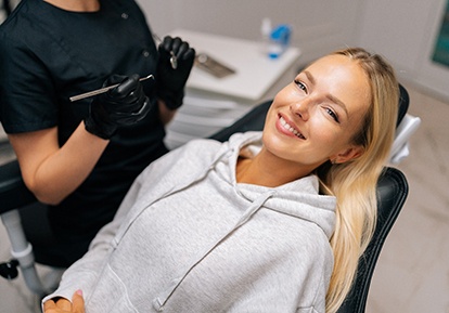 Patient reclined in treatment chair smiling