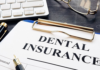 Paperwork representing dental insurance coverage for Invisalign in Plainview