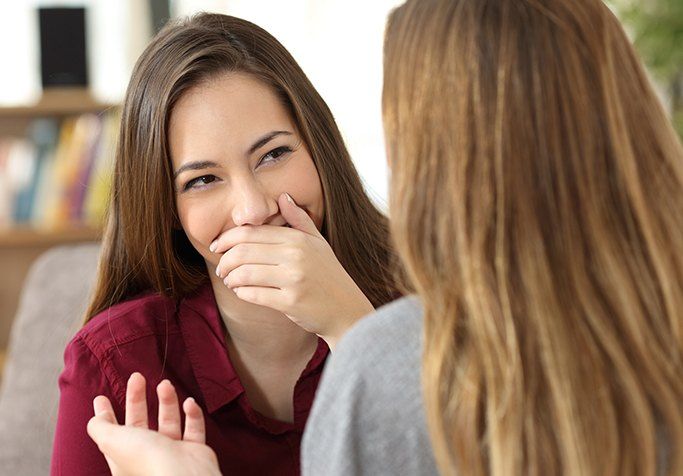 woman covering smile