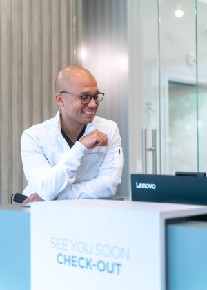 Plainview Dentist smiling at front desk