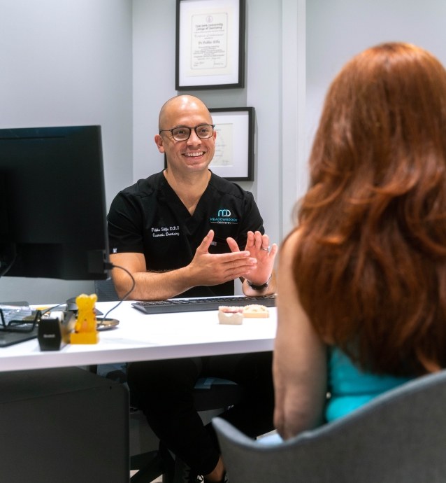 Plainview Dentist, Dr. Silfa consulting a patient