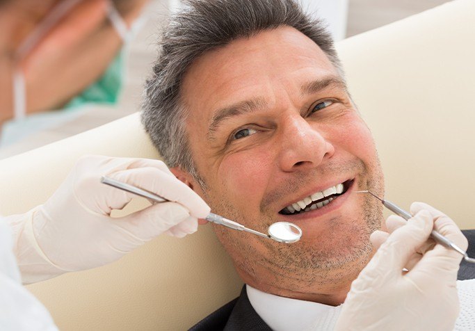 man having a teeth cleaning done