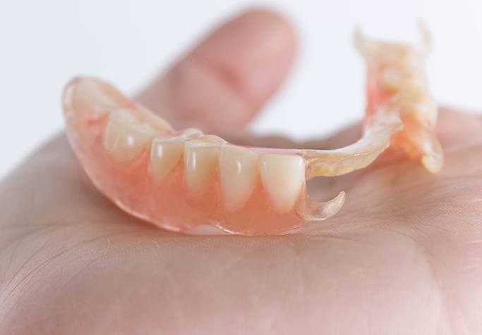 partial denture in hand