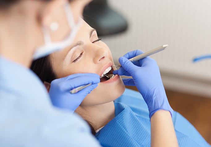 woman sedated having dental work done