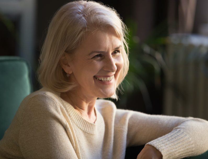 woman smiling on green couch