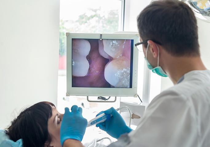 Dentist using intraoral camera