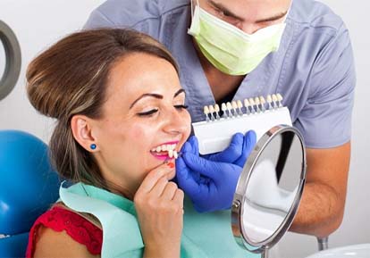 woman trying on veneers in Plainview