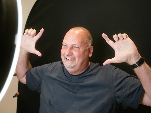 Dental patient Danny gesturing to his grin