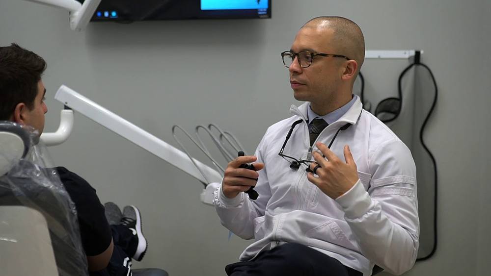 Plainview dentist talking to a patient in the dental chair