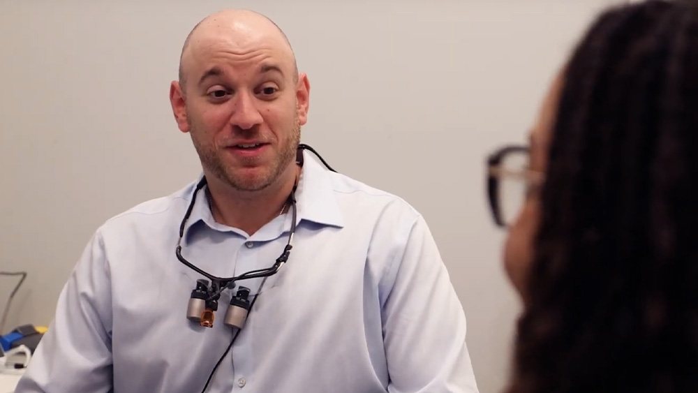 Plainview dentist talking to a patient in the dental chair