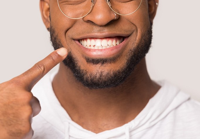 smiling man after understanding the cost of teeth whitening in Plainview