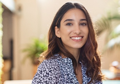 smiling woman after considering the factors affecting the cost of teeth whitening