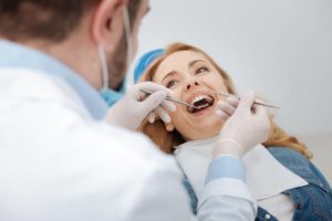 Dentist talking to woman in dental chair