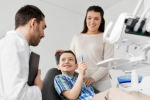 young boy and mother at dentist