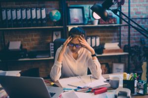 person sitting at a desk, stressed out