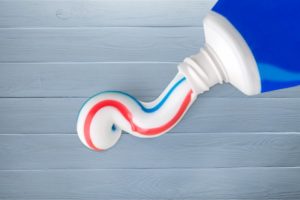 Too much toothpaste coming out of a blue toothpaste tube