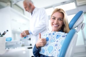 woman giving thumbs up while visiting dentist in Plainview