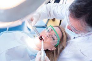 dentist in Plainview treating young woman 