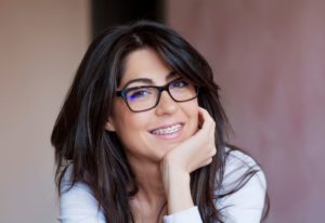 Smiling woman with dark hair and braces