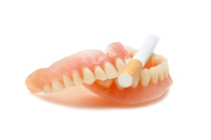 Set of dentures with cigarette