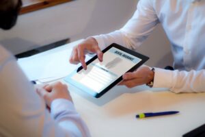 Dentist helping patient with dental insurance form.